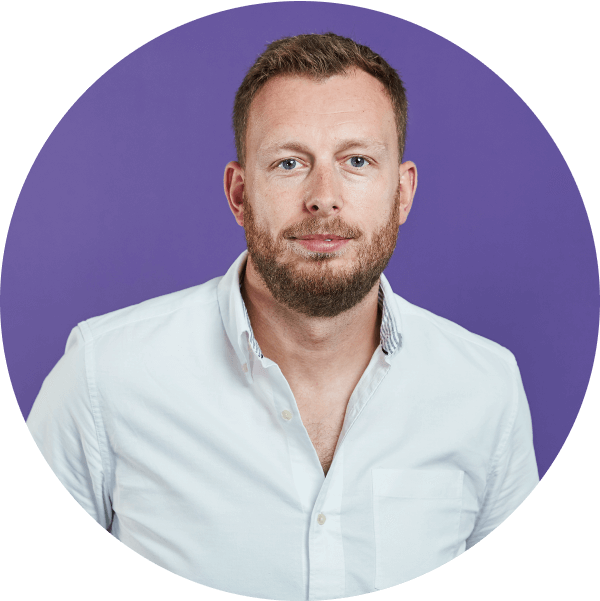 Smiling man in white shirt on a purple circular background